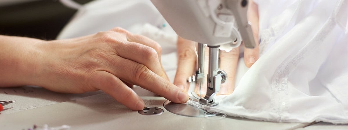 One of the Eticlò workers sewing with a sewing machine.