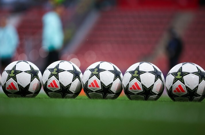 Footballs arranged in a line on the field.