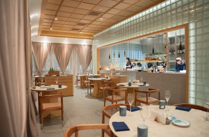 The interior of Gen restaurant with chefs preparing food in the open kitchen.