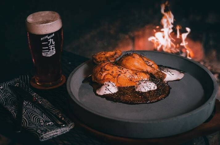 A dish served at Blue Smoke accompanied by a pint of craft beer in Singapore.