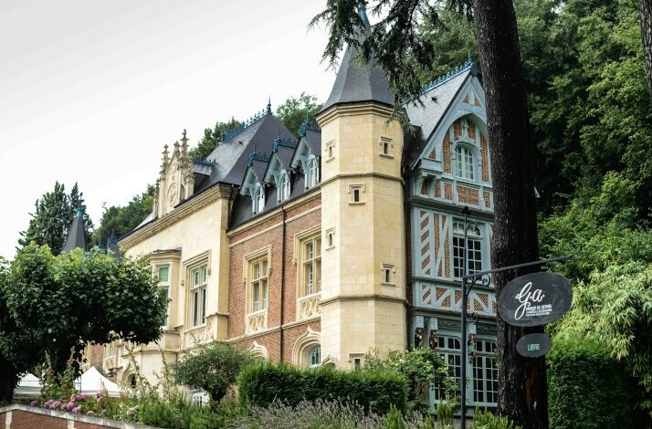 A large light-colored stone building with a grey slate roof where Restaurant G.a. is located