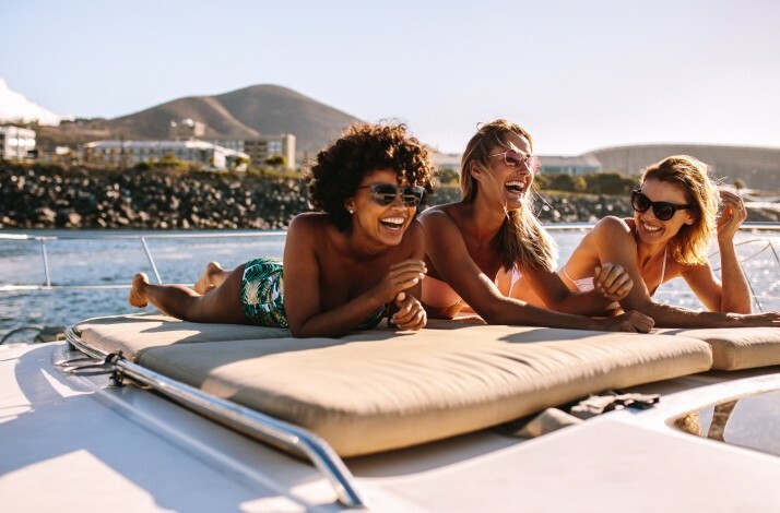 A group of people sunbathing on a boat tour of Guanabara Bay