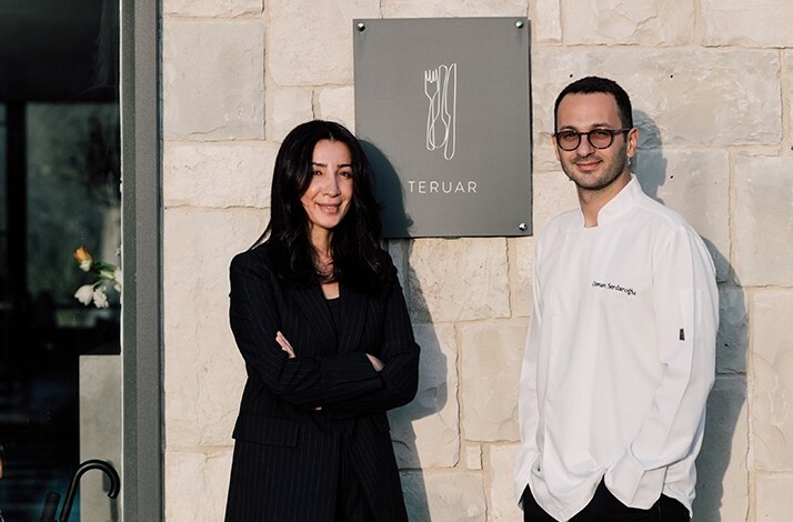 Ezgi Serdaroğlu, Experience Curator, and Osman Serdaroğlu’s, Chef, stand in front of Teruar Urla building