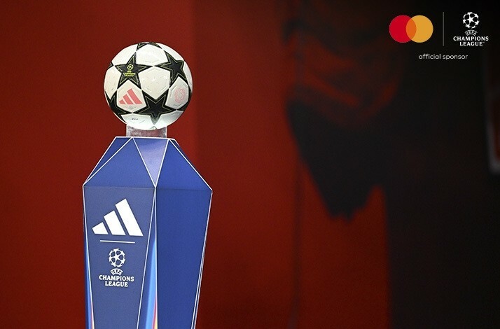 A close shot of the UEFA Champions League trophy. The image is featuring UEFA and Mastercard logos on the top right corner